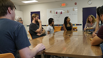 Juliann Salinas talks with students about the history of the program. 