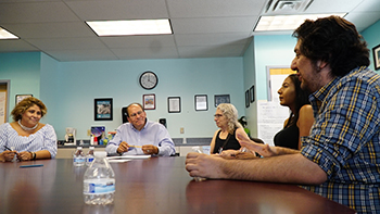 Students discuss programs at PB & J. 